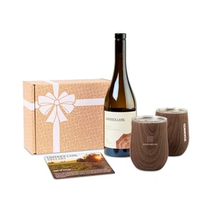 red wine bottle with two stemless wine glasses, catalog, and branded box packaging